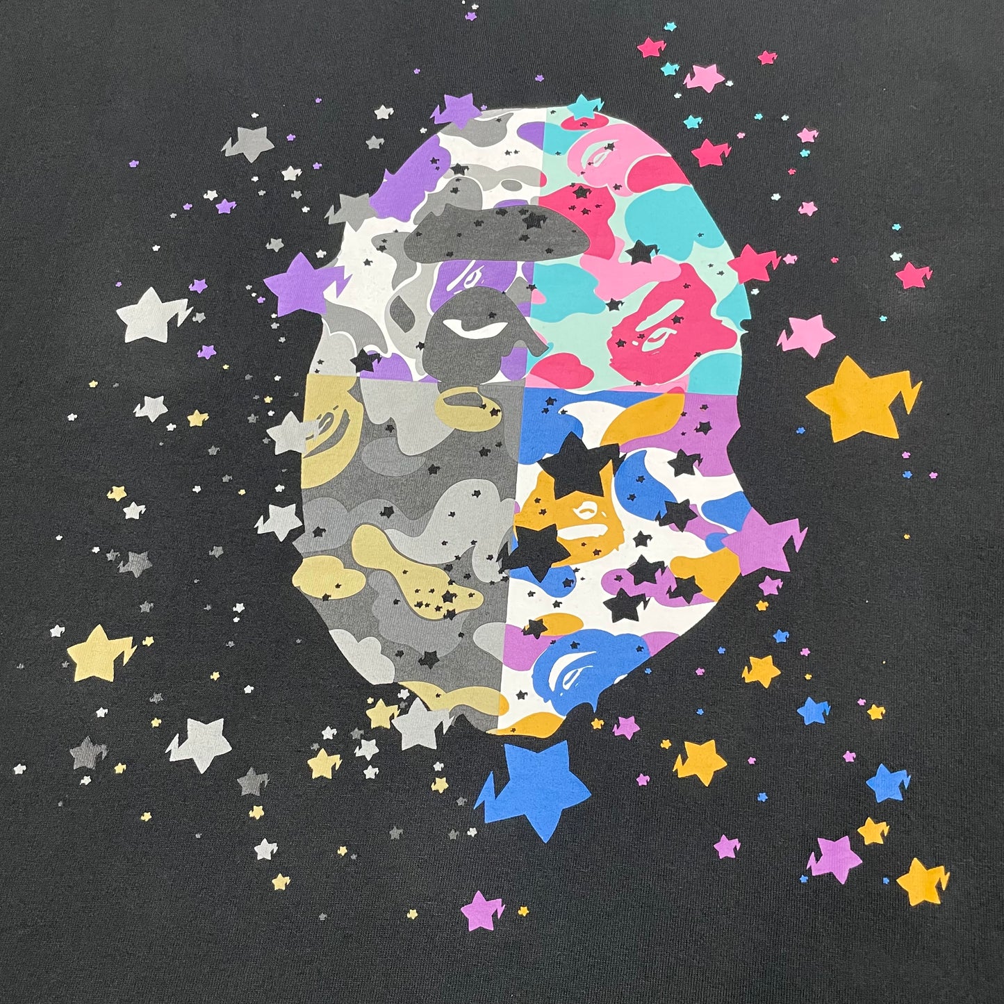 Close-up of colorful STA graphics on black BAPE Ape Head T-shirt
Four-panel multicolor camo Ape Head print on black BAPE T-shirt
Detailed front print on black BAPE US Ape Head STA T-shirt