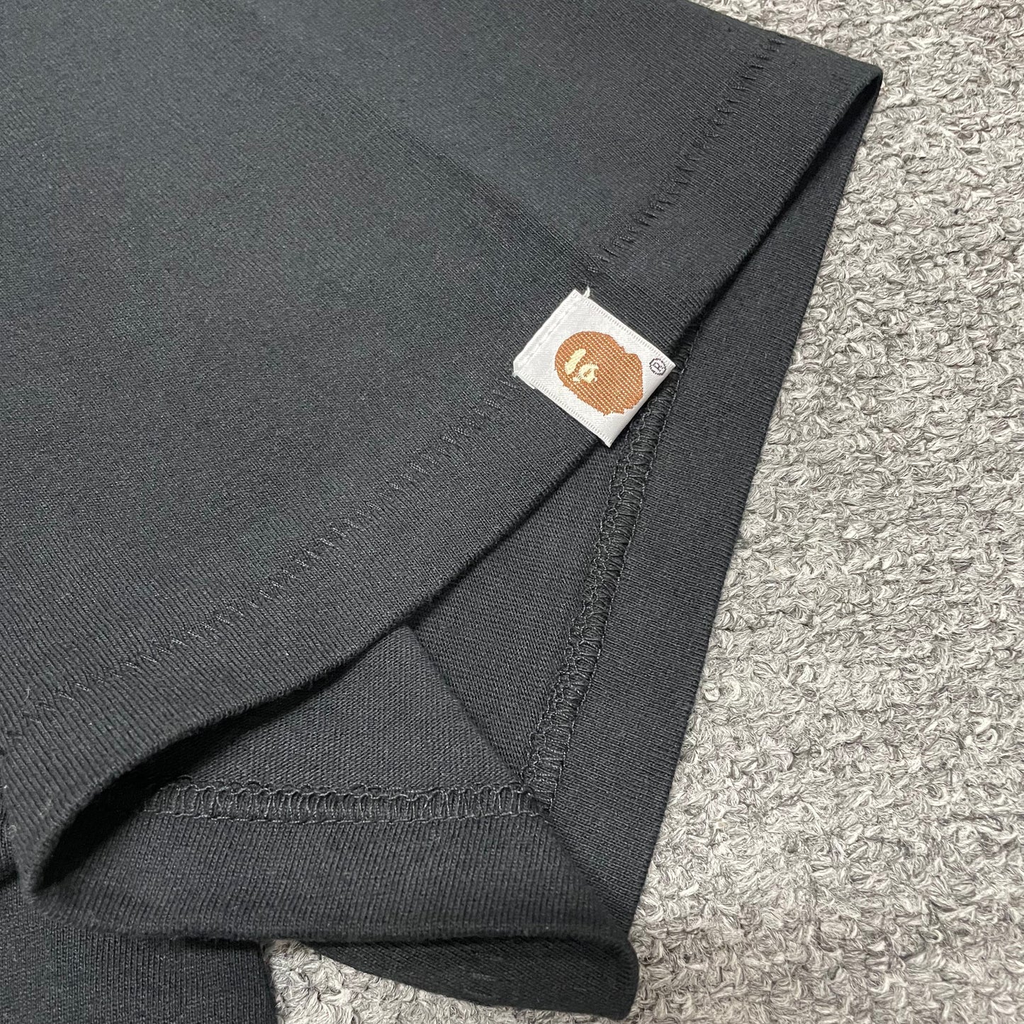BAPE Ape Head sleeve label detail on black US Ape Head STA T-shirt