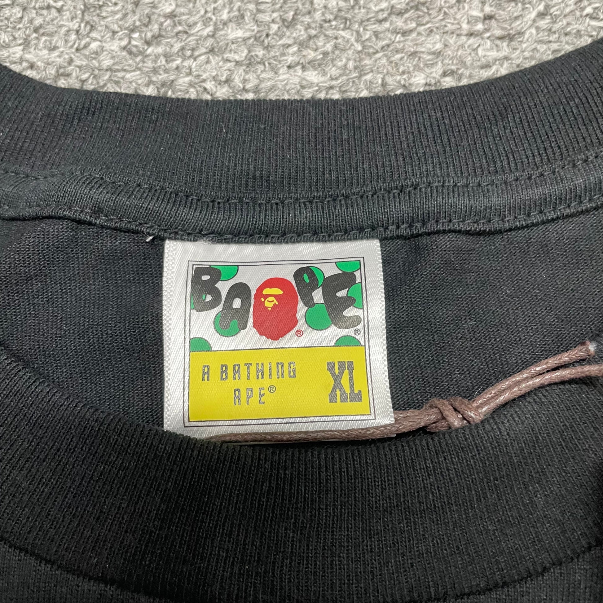 BAPE neck label detail on black Space Camo College T-shirt