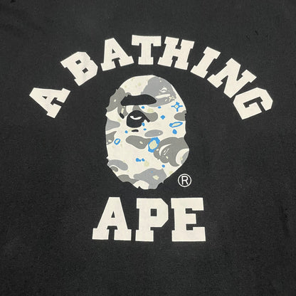 White and grey Space Camo College graphic on black BAPE T-shirt
Close-up of white Space Camo Ape Head graphic on black BAPE T-shirt
Detailed grey white and blue Space Camo pattern on black BAPE T-shirt

