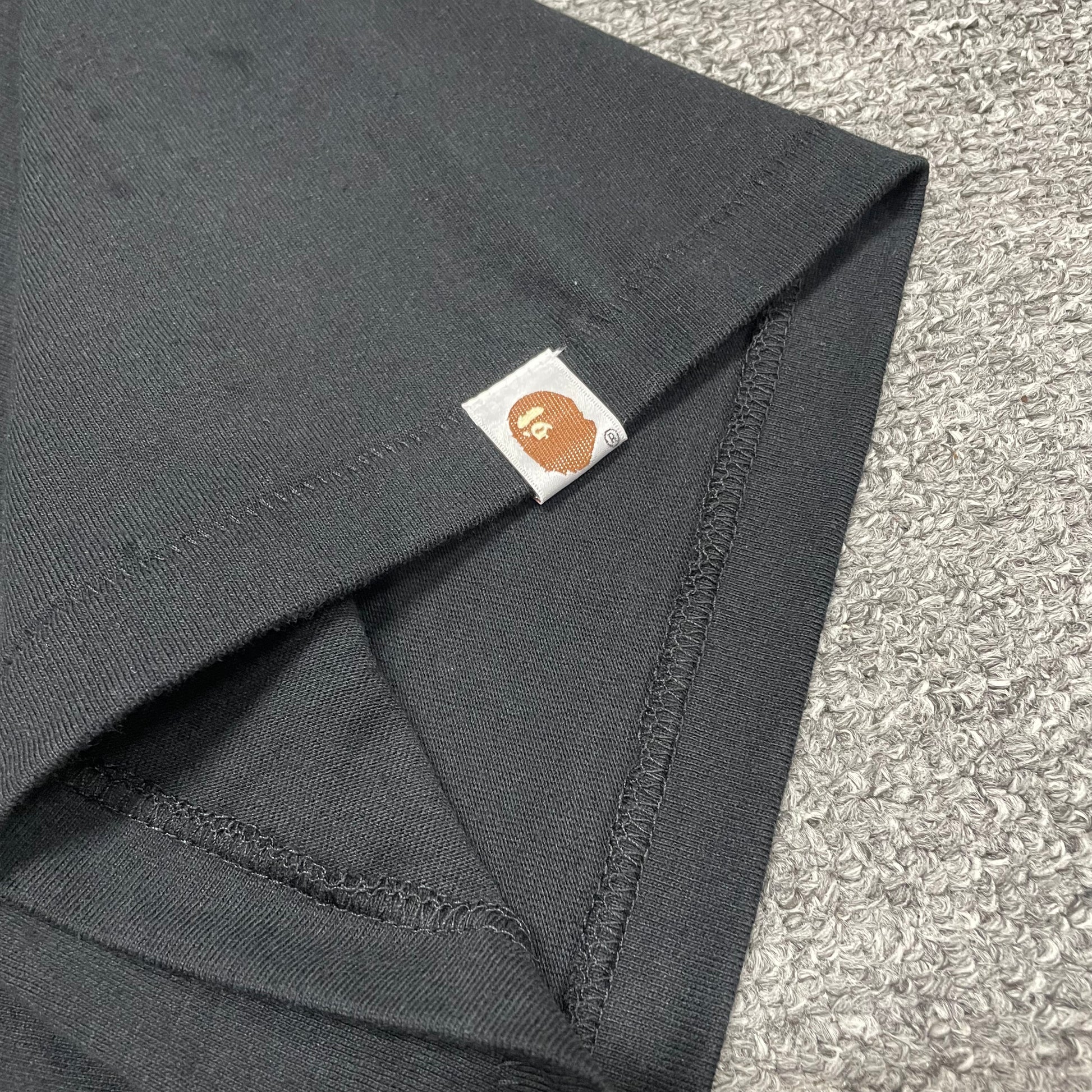 BAPE Ape Head sleeve label detail on black Space Camo College T-shirt