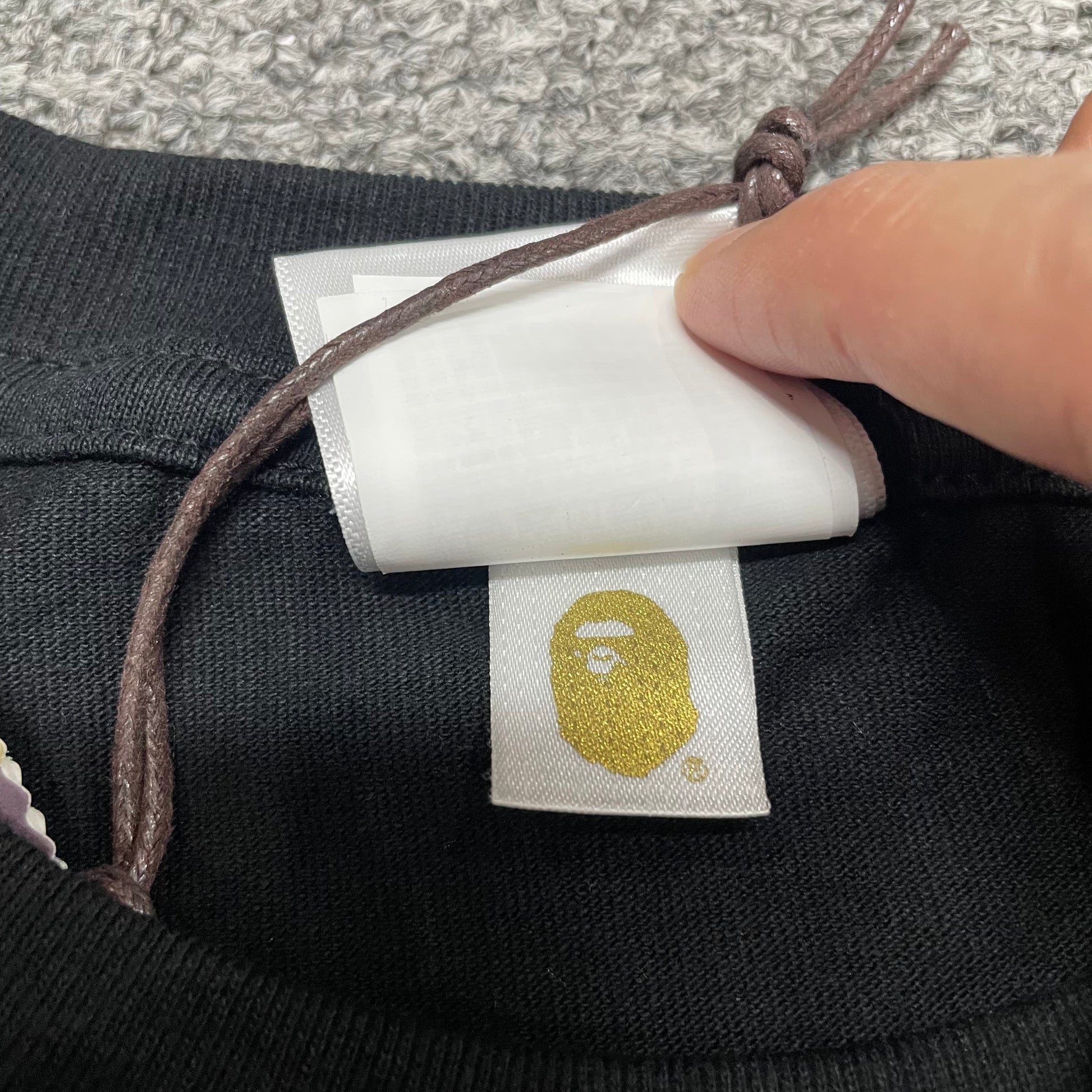 Gold label detail on black BAPE Space Camo College T-shirt