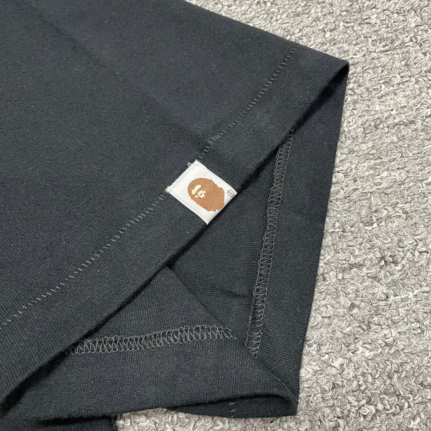 BAPE Ape Head sleeve label detail on black Space Camo T-shirt