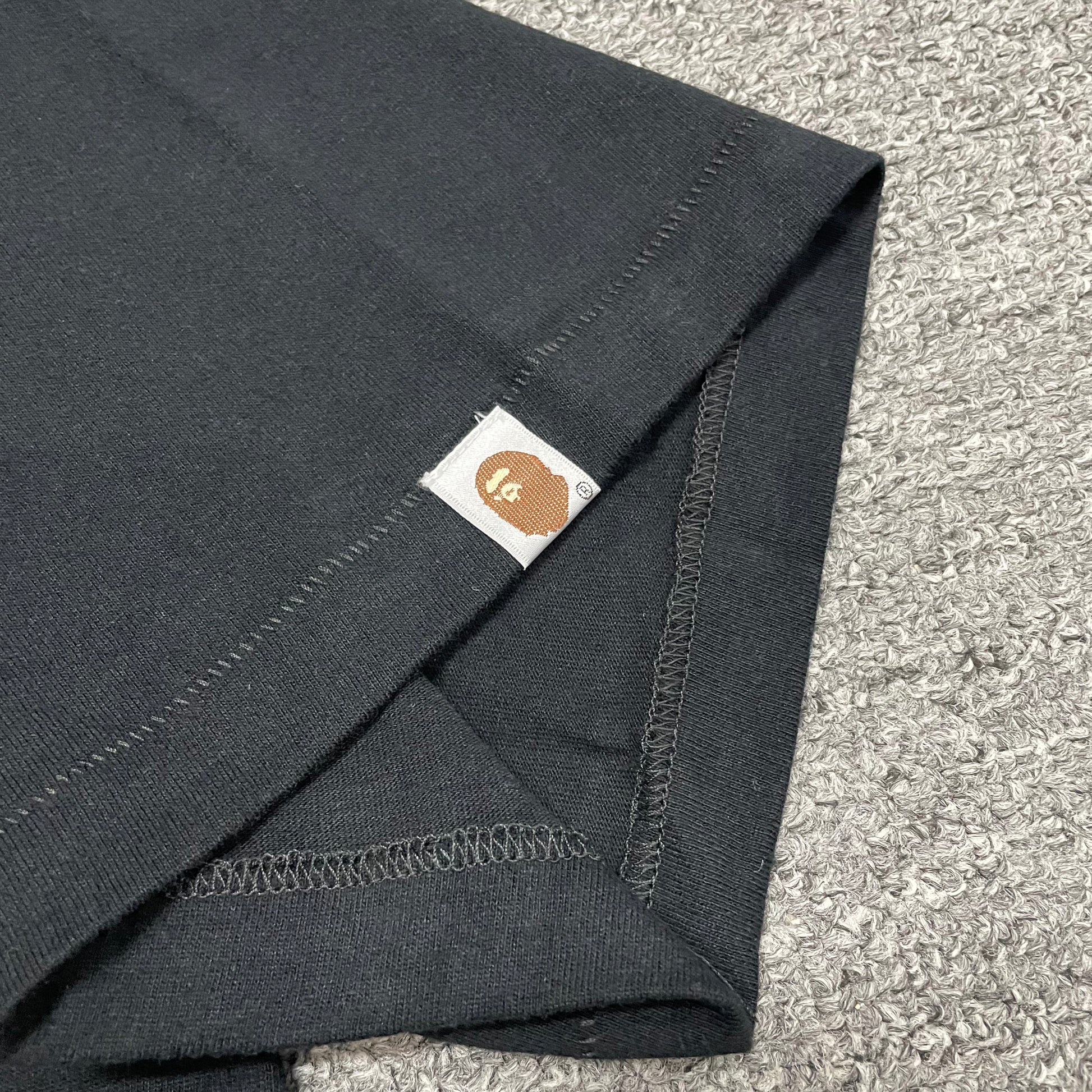 BAPE Ape Head sleeve label detail on black Space Camo T-shirt