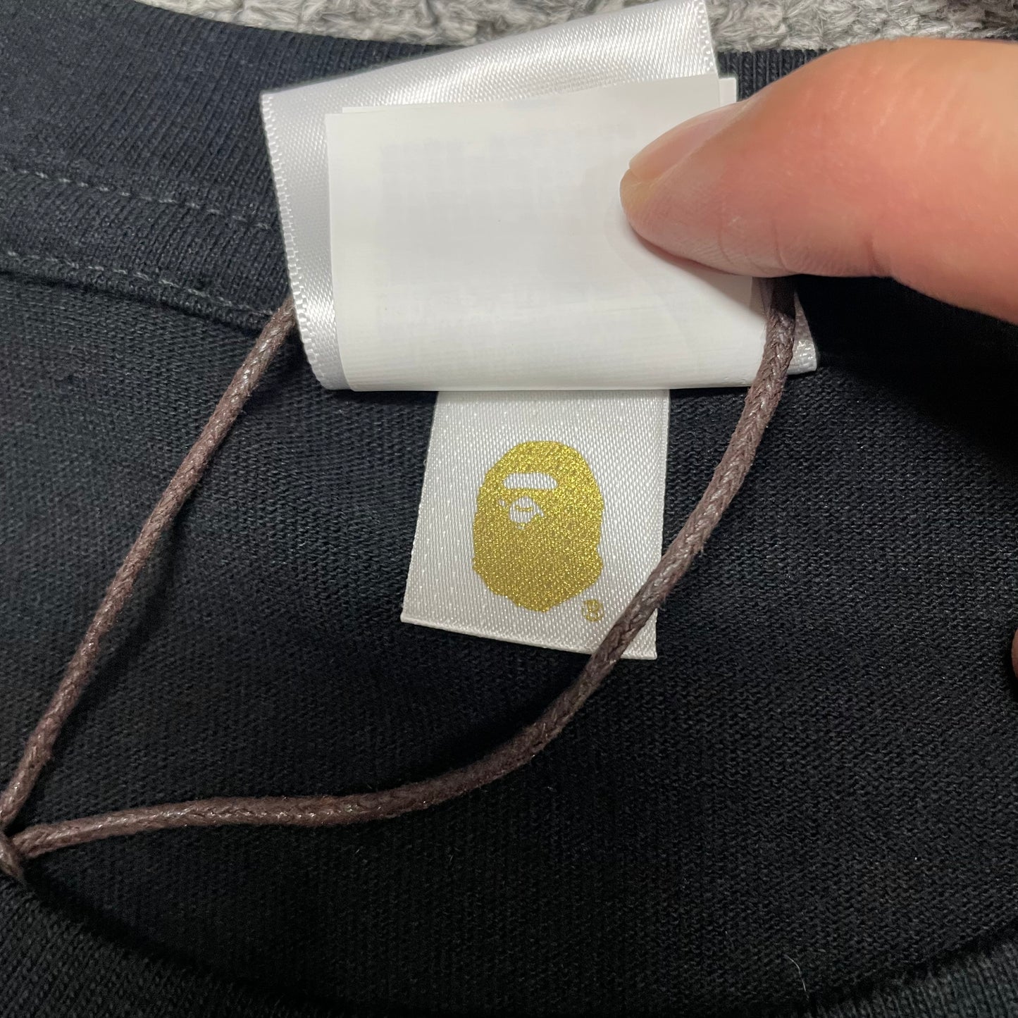 Gold label detail on black BAPE Space Camo By Bathing Ape T-shirt