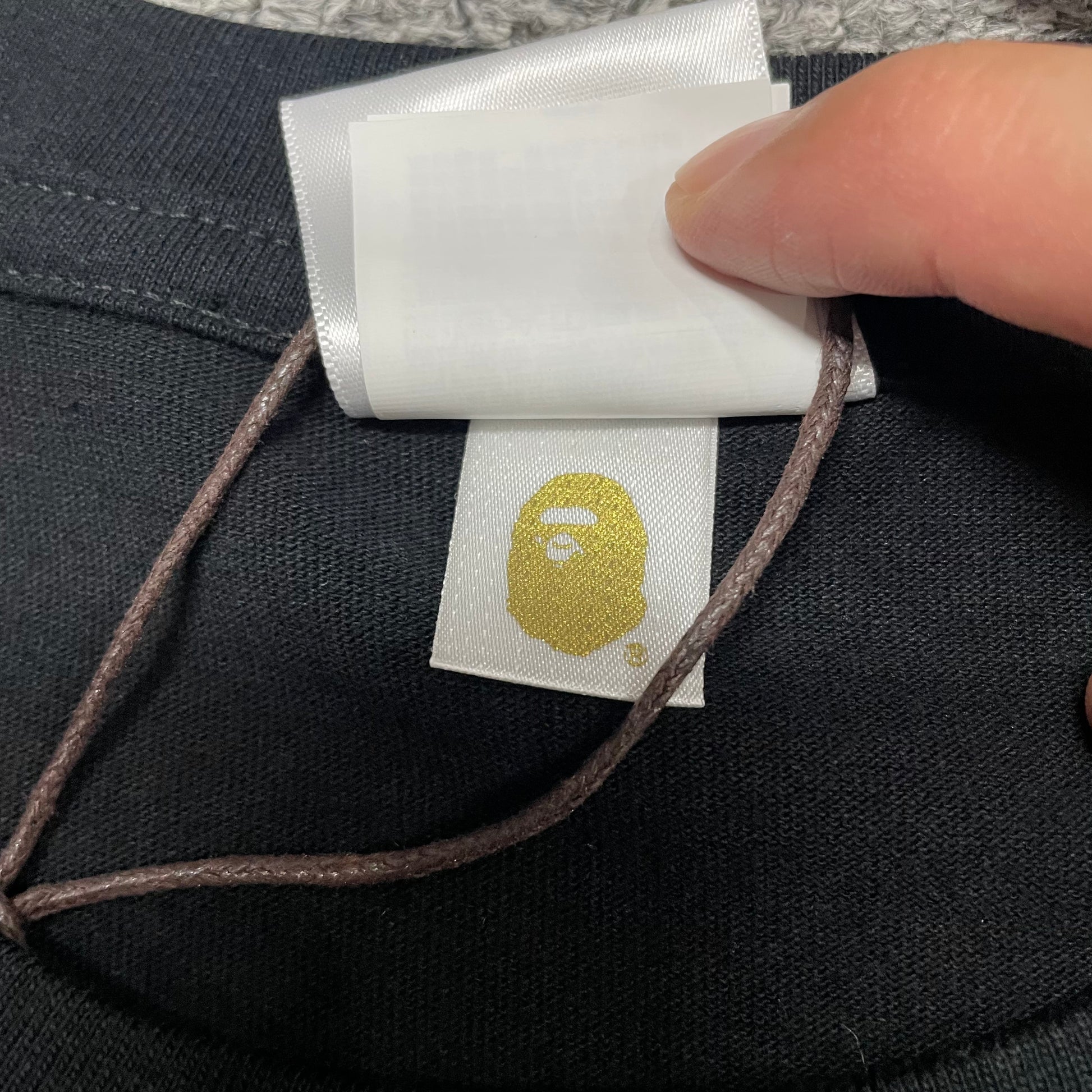 Gold label detail on black BAPE Space Camo By Bathing Ape T-shirt