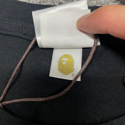 Gold label detail on black BAPE Space Camo By Bathing Ape T-shirt