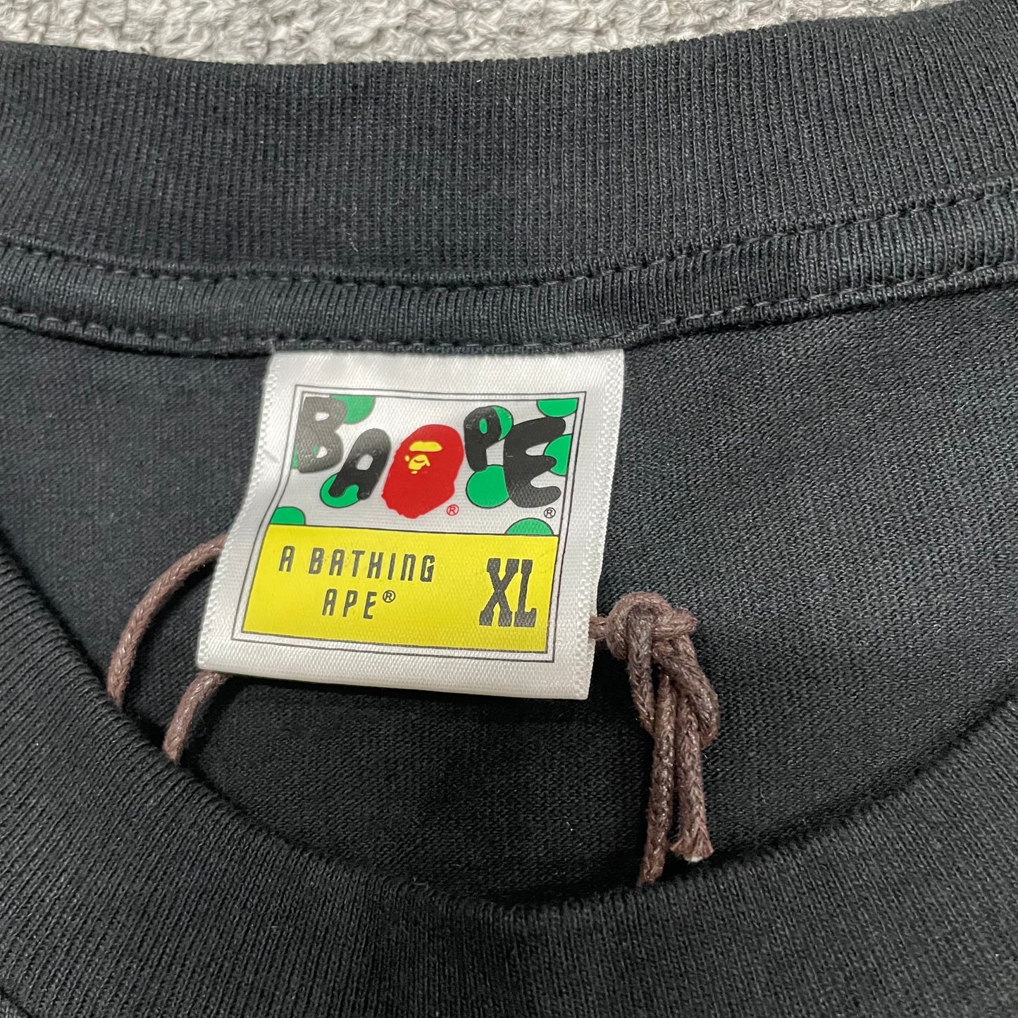 BAPE neck label detail on black ABC Camo Big Ape Head T-shirt