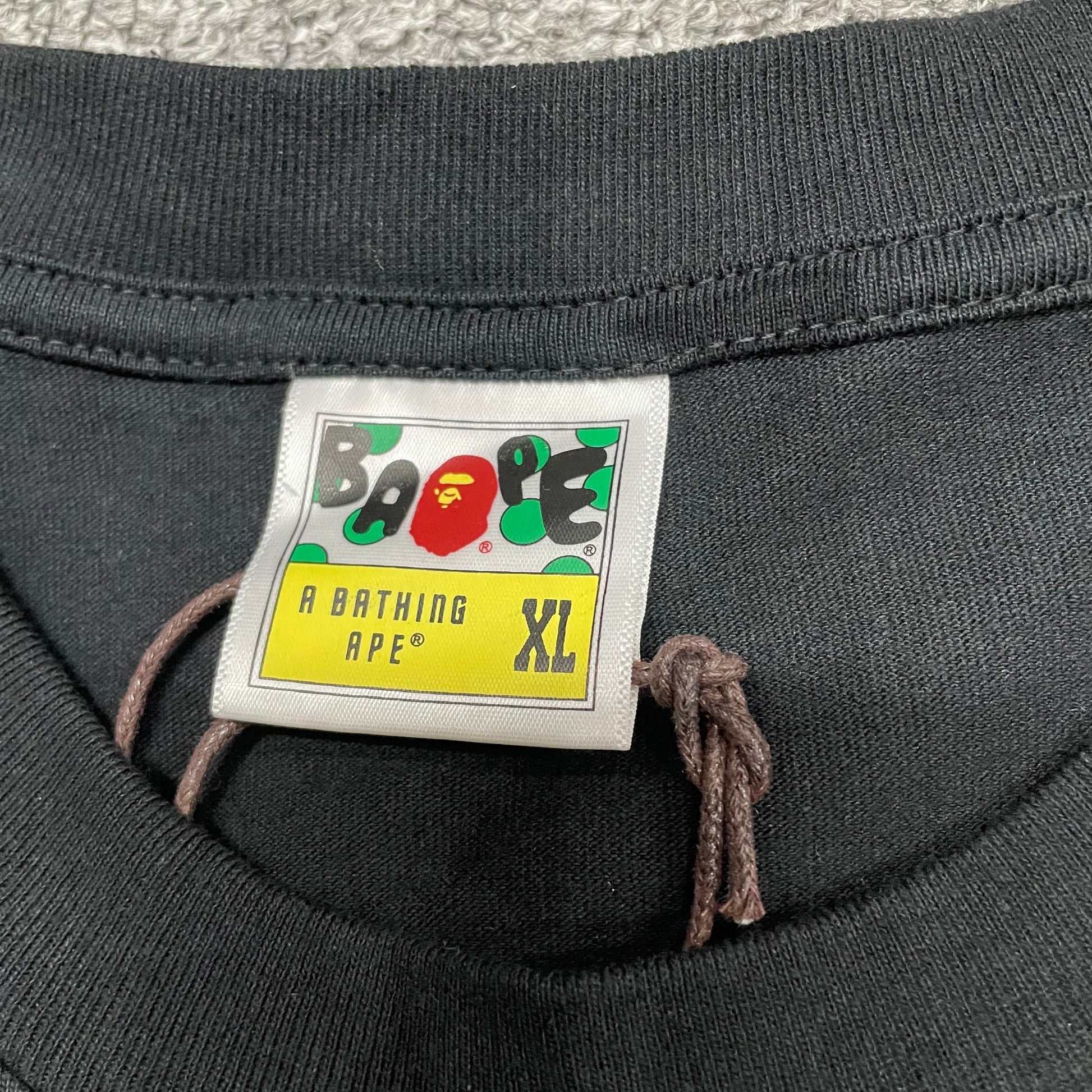 BAPE neck label detail on black ABC Camo Big Ape Head T-shirt