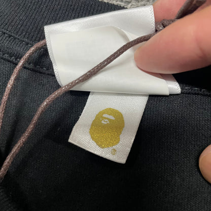 Gold label detail on black BAPE ABC Camo Big Ape Head T-shirt