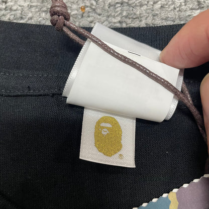 Gold label detail on black BAPE Color Camo Big Ape Head T-shirt