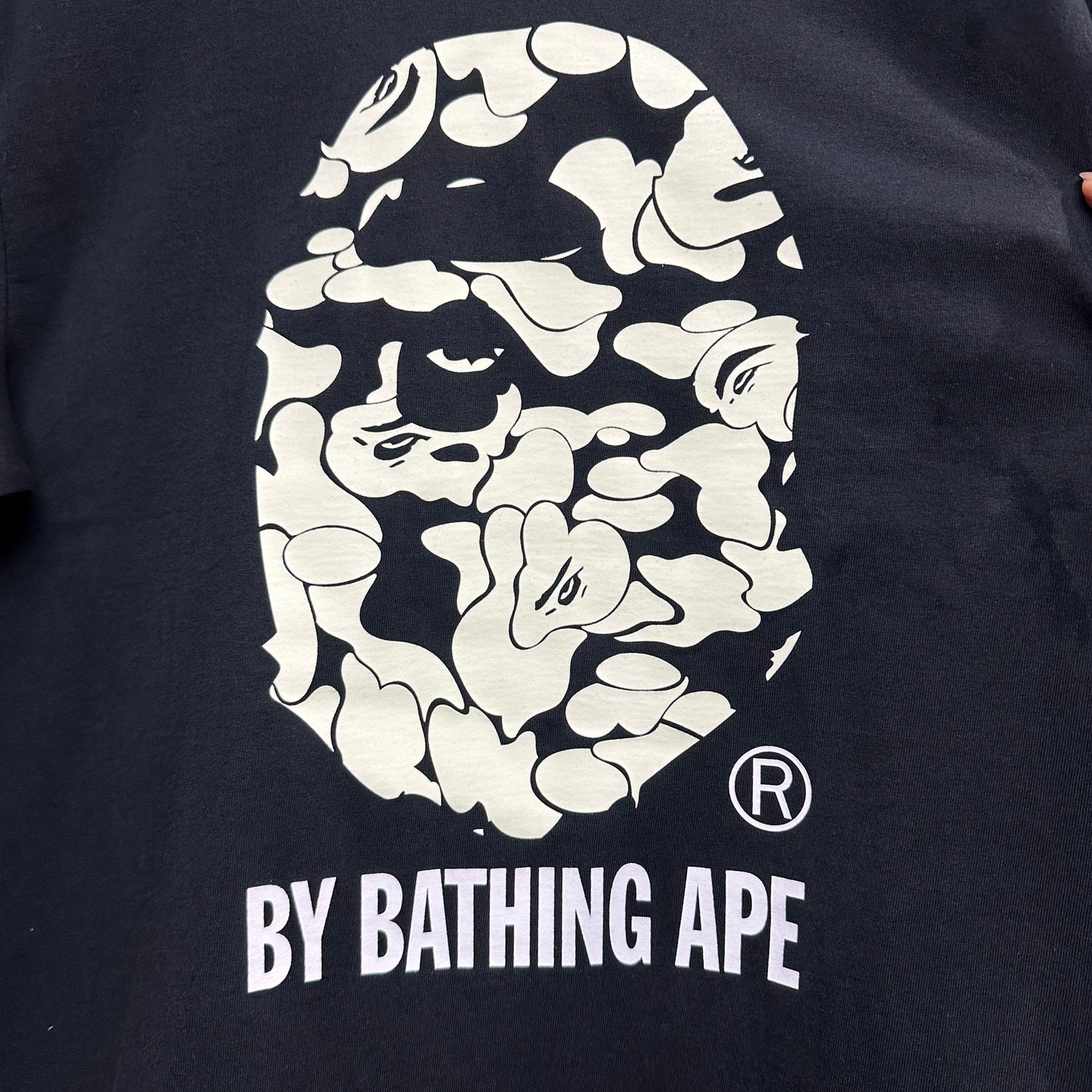 Pale green Sakura camouflage graphic on black streetwear T-shirt