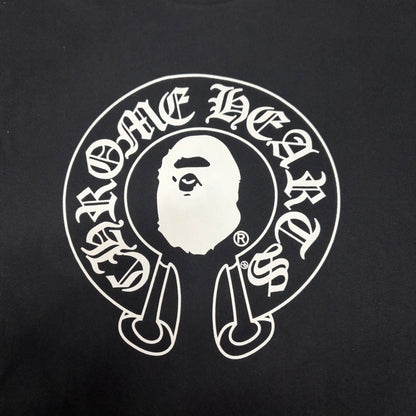White Chrome Hearts horseshoe and Ape Head graphic on black BAPE T-shirt
Close-up of white BAPE x Chrome Hearts front graphic on black T-shirt
Gothic Chrome Hearts lettering detail on black BAPE collaboration T-shirt
Close-up of white Ape Head logo on black BAPE x Chrome Hearts T-shirt