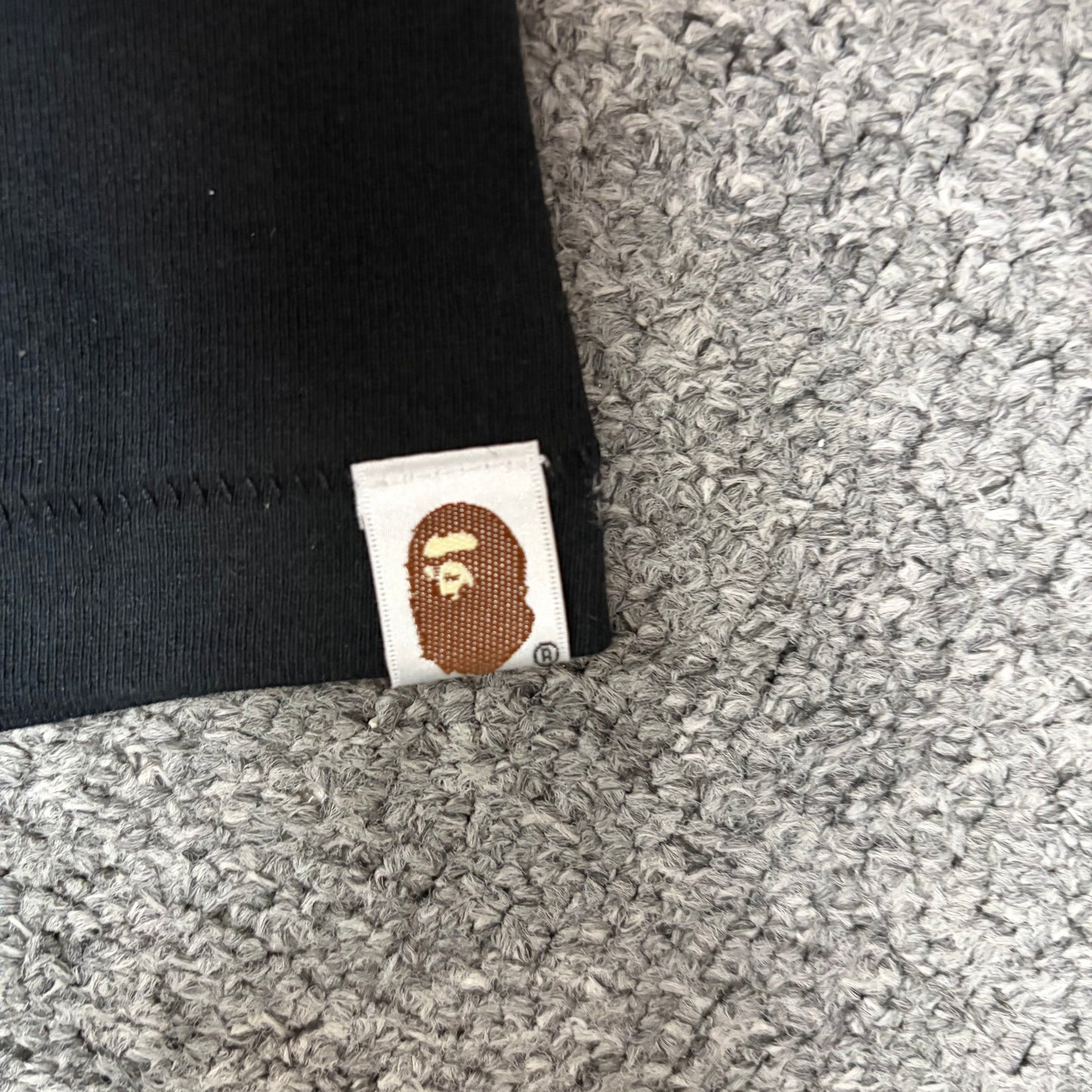 BAPE Ape Head sleeve label detail on black Chrome Hearts collaboration T-shirt
Sleeve hem and label detail of black BAPE x Chrome Hearts T-shirt