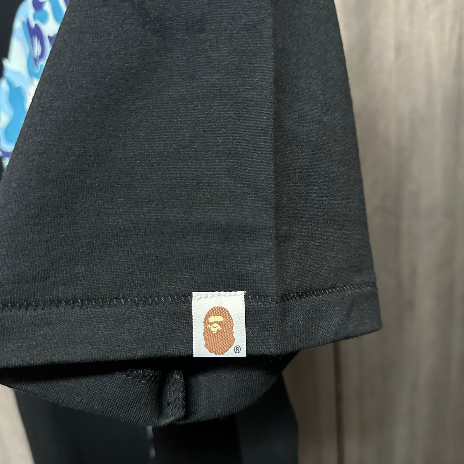 BAPE Black graphic T-shirt sleeve label and stitching detail