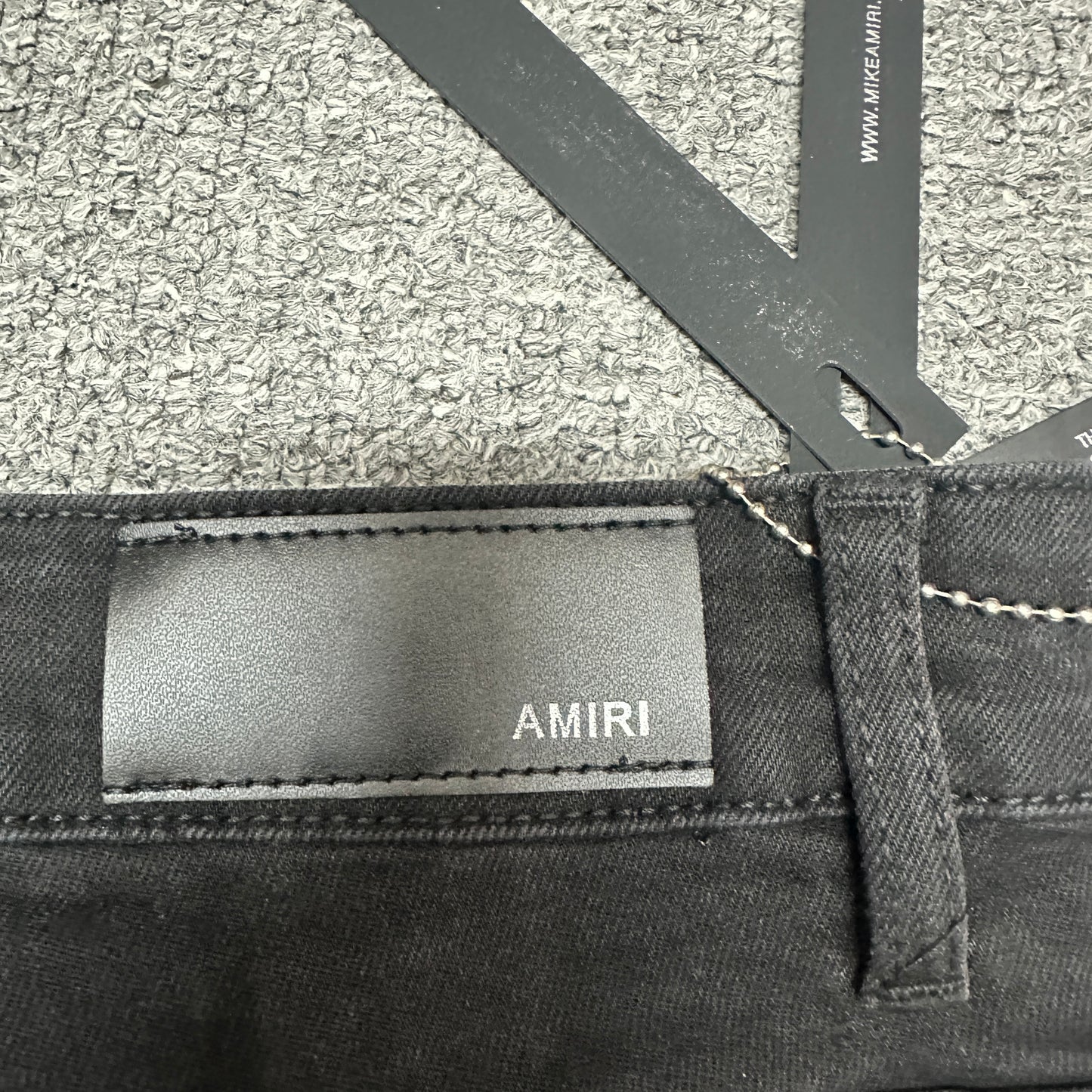 AMIRI Staggered Logo Distressed Skinny Jeans Washed Black