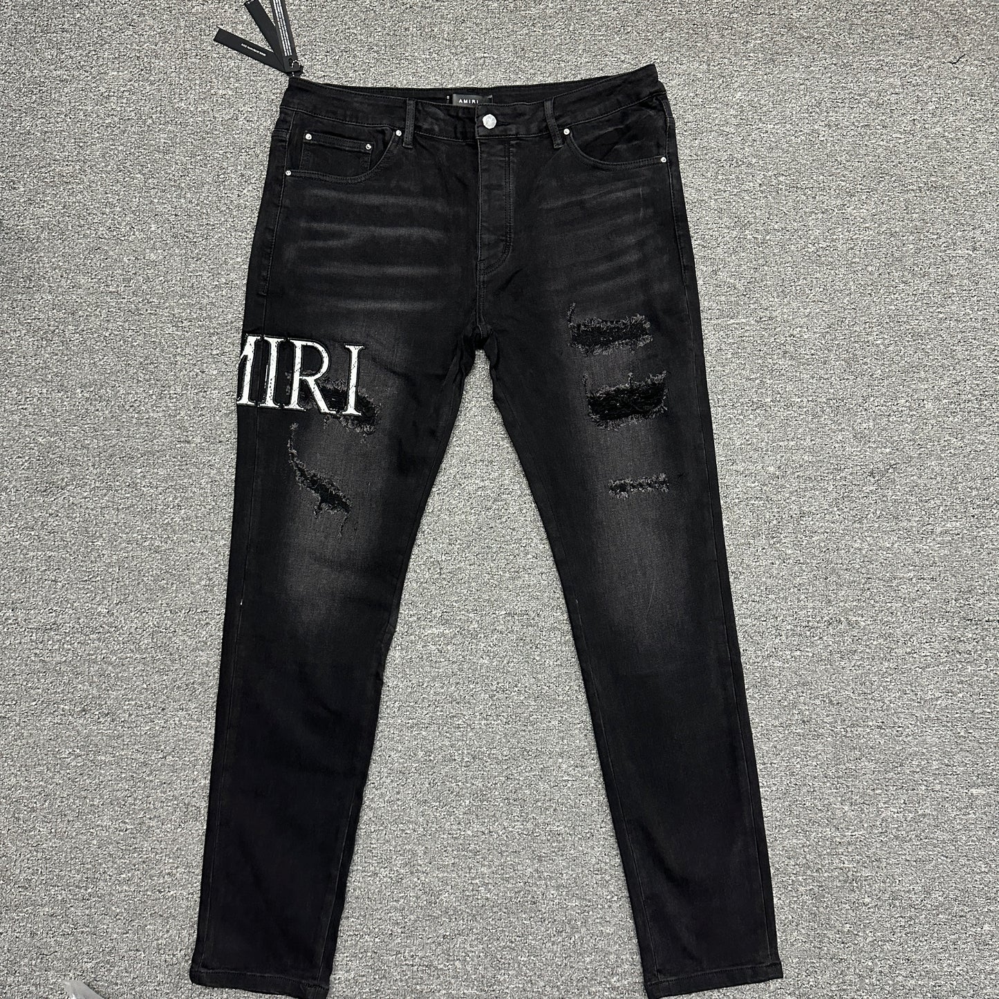 AMIRI Staggered Logo Distressed Skinny Jeans Washed Black
