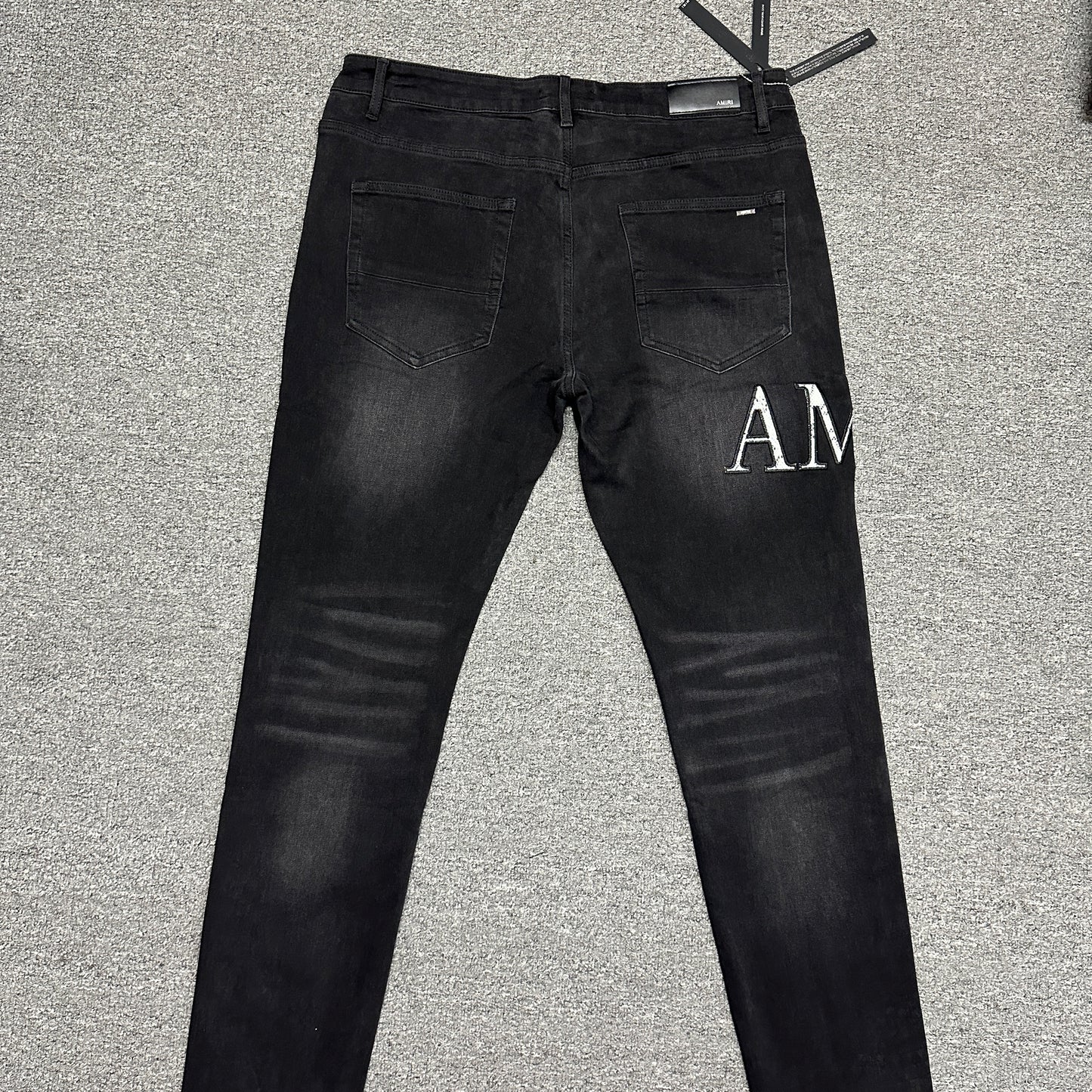AMIRI Staggered Logo Distressed Skinny Jeans Washed Black