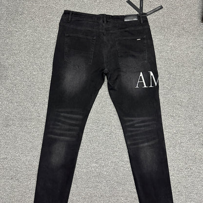 AMIRI Staggered Logo Distressed Skinny Jeans Washed Black