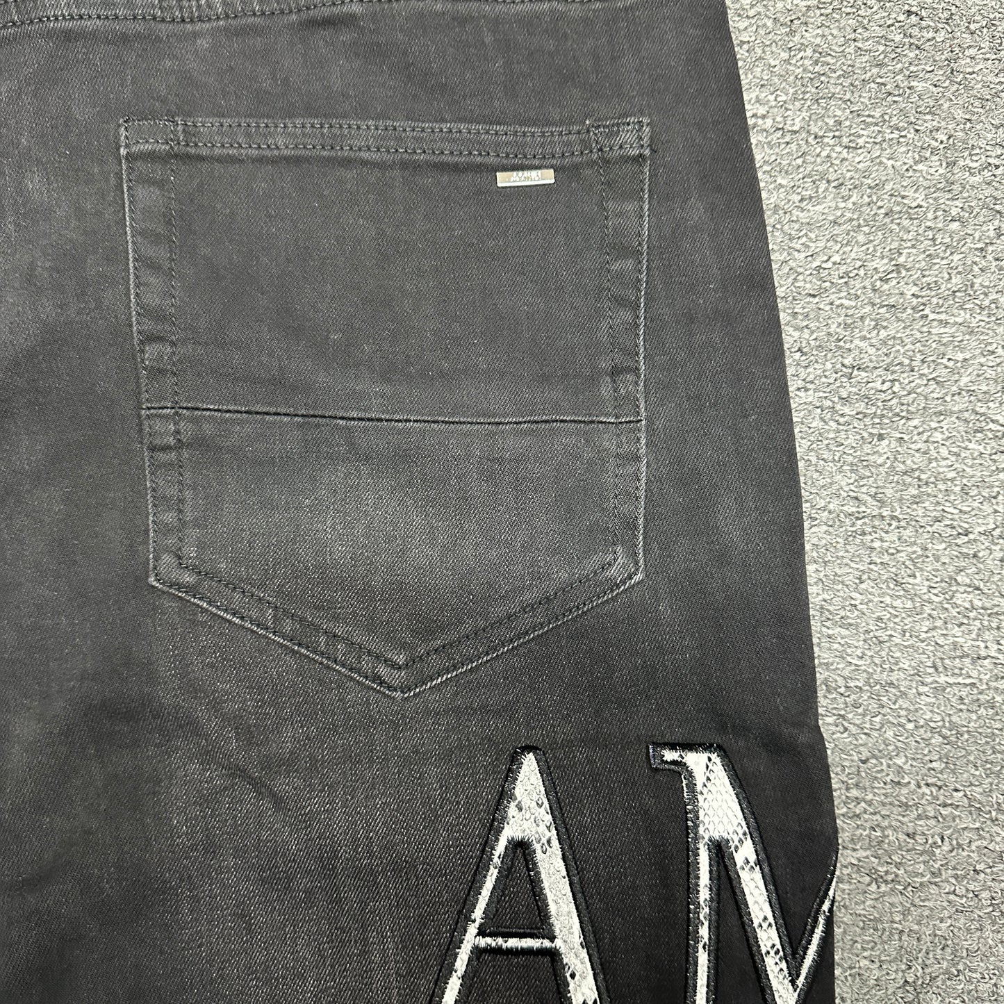 AMIRI Staggered Logo Distressed Skinny Jeans Washed Black