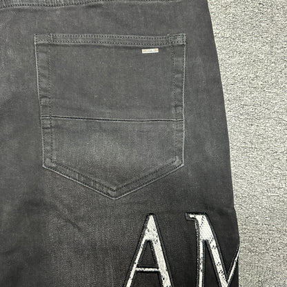 AMIRI Staggered Logo Distressed Skinny Jeans Washed Black