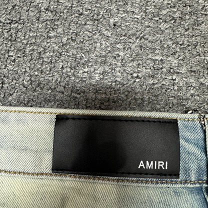 AMIRI Staggered Logo Distressed Skinny Jeans Antique Indigo