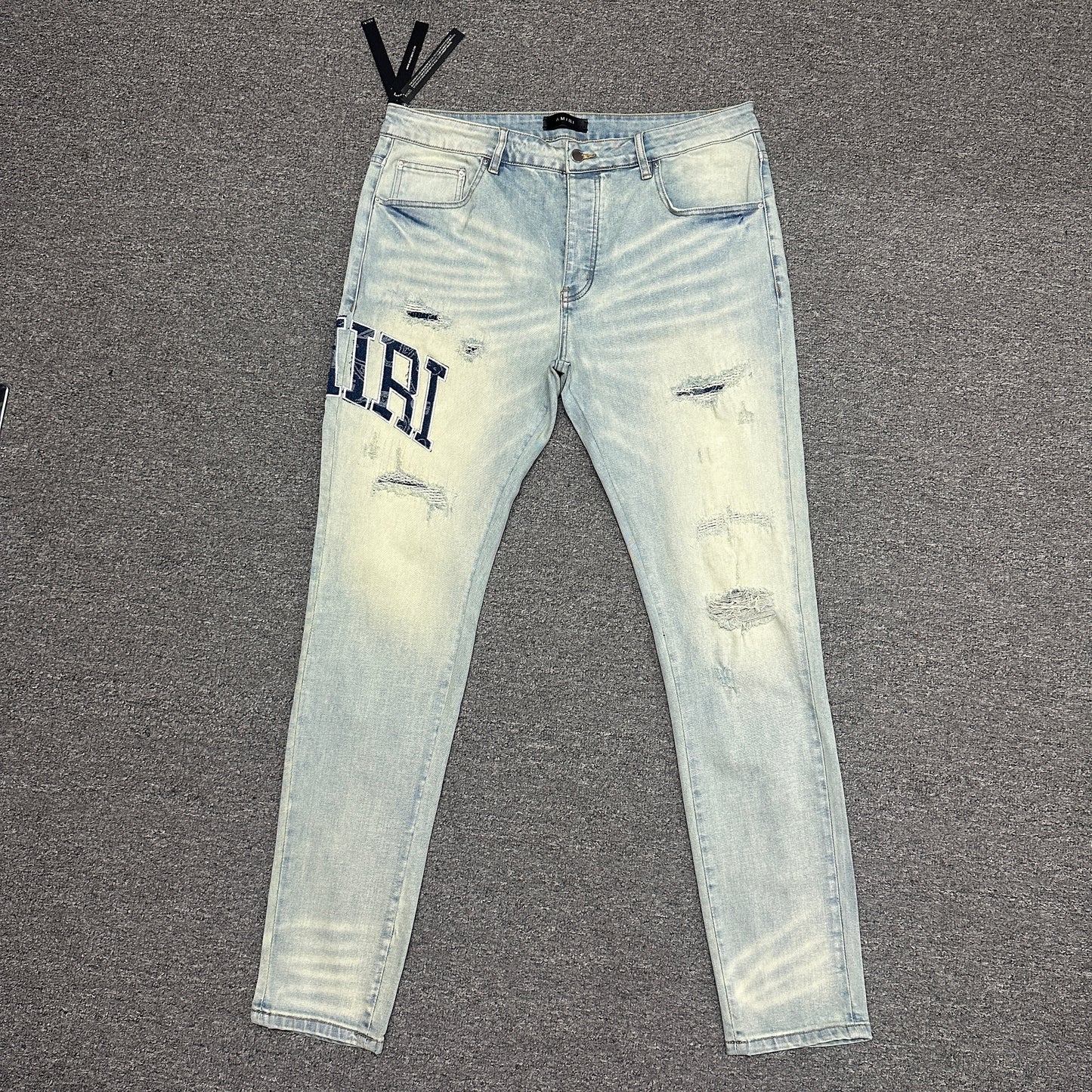 AMIRI Staggered Logo Distressed Skinny Jeans Antique Indigo