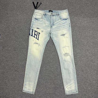 AMIRI Staggered Logo Distressed Skinny Jeans Antique Indigo