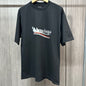Black crew neck short‑sleeve tee hanging on wooden hanger, front‑view with distressed BALENCIAGA red‑white wave logo print on chest