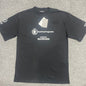 Black short-sleeve crew neck t-shirt front flat lay, complete World Food Programme emblem and BALENCIAGA letter print on chest, brand paper hang tag attached to collar