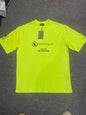 Bright neon yellow oversized cotton tee front flat shot with the themed chest logo and hang tag