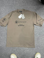 Khaki taupe relaxed fit tee front lay, subtle printed pattern on chest and sleeves with brand tags