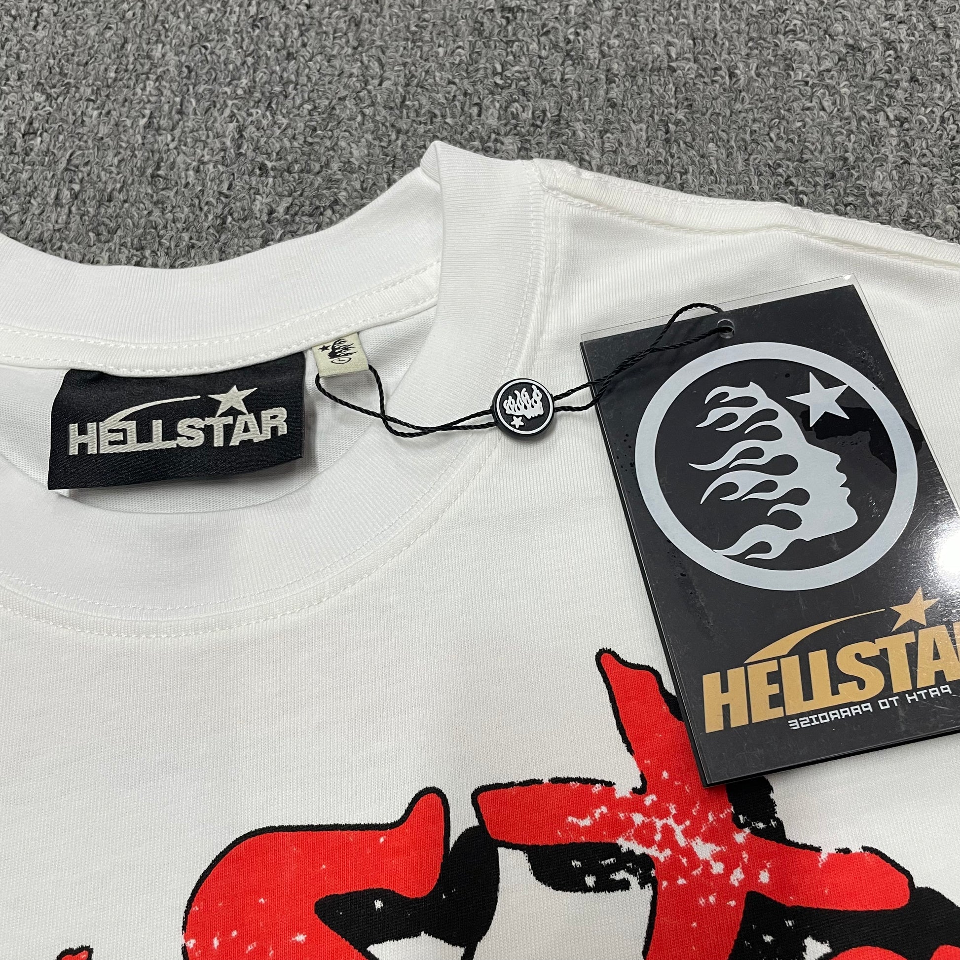 Hellstar branded neck label and crew-neck stitching detail on the graphic T-shirt
Hellstar Records branded hangtag attached to the Is This What Heaven Sounds Like T-Shirt