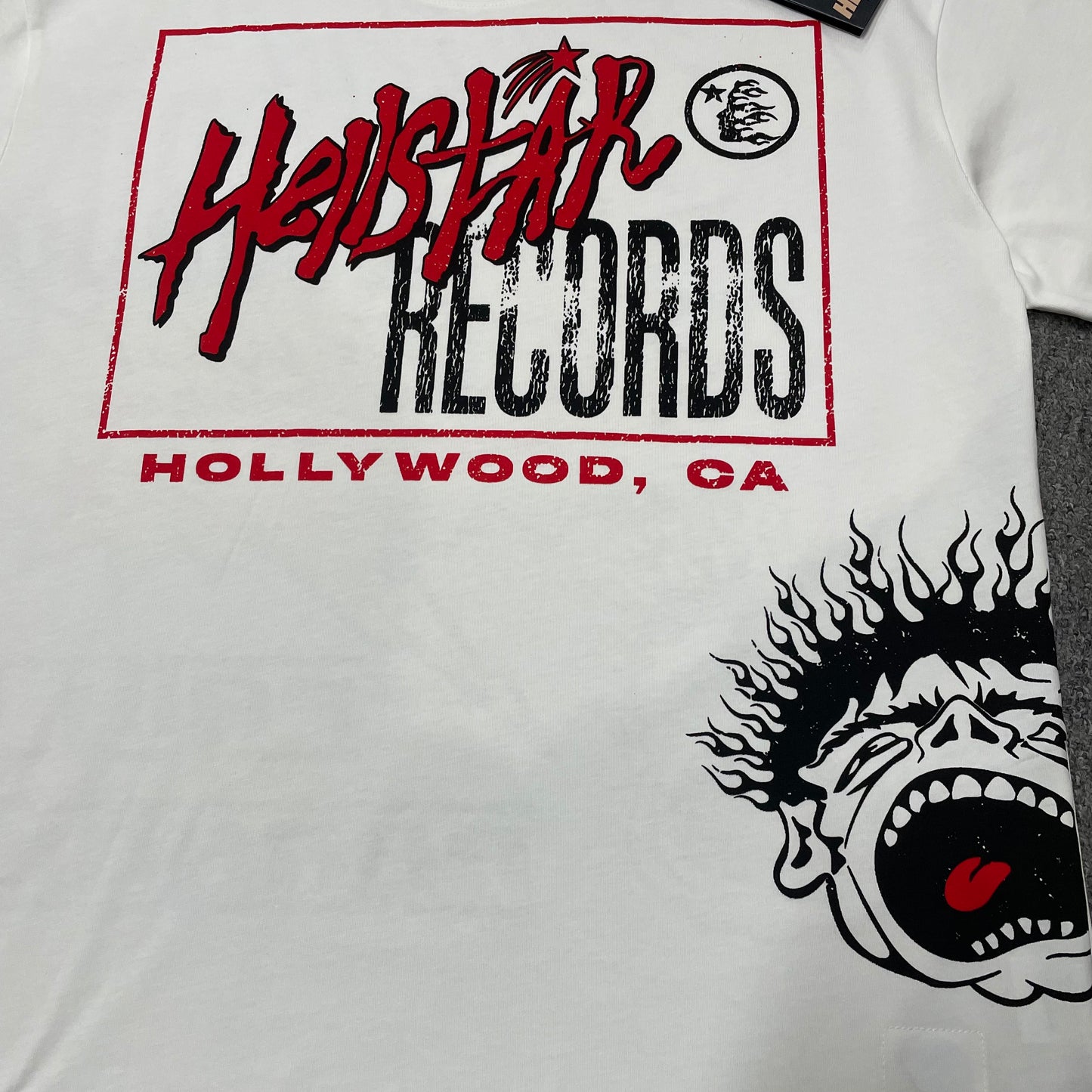 Full Hellstar Records Hollywood graphic print on the Path to Paradise T-Shirt
Close-up of the distressed Hellstar Records and Hollywood lettering print
Detailed view of the distressed red black and white print texture on the Hellstar T-Shirt
Oversized screaming-face side graphic with flame details on the Hellstar Path to Paradise T-Shirt
Close-up of the flame and open-mouth side artwork on the Hellstar graphic T-shirt
Full back graphic artwork on the Hellstar Path to Paradise Records T-Shirt