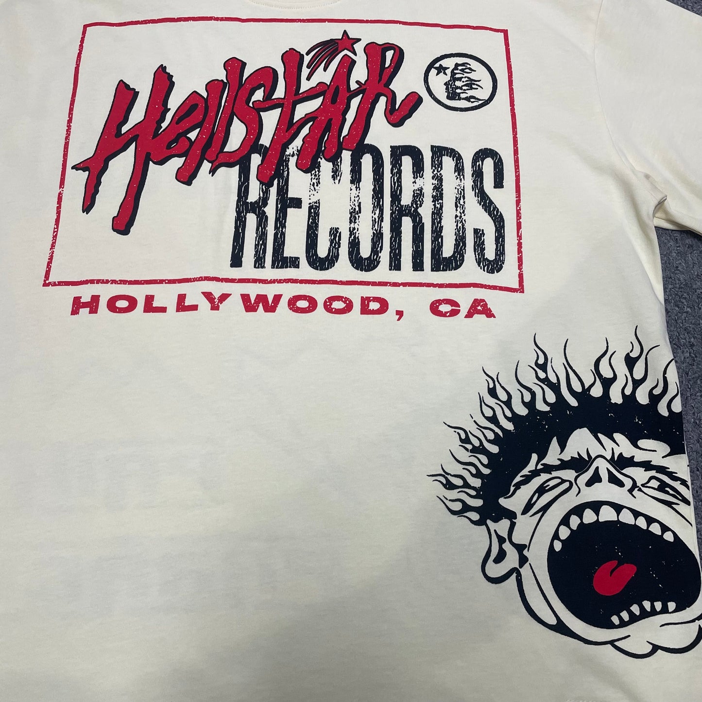 Full Hellstar Records Hollywood graphic print on the Path to Paradise T-Shirt
Close-up of the distressed Hellstar Records and Hollywood lettering print
Detailed view of the distressed red black and white print texture on the Hellstar T-Shirt
Oversized screaming-face side graphic with flame details on the Hellstar Path to Paradise T-Shirt
Close-up of the flame and open-mouth side artwork on the Hellstar graphic T-shirt
Full back graphic artwork on the Hellstar Path to Paradise Records T-Shirt