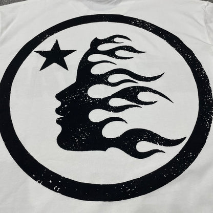 Full oversized Hellstar Sports wordmark graphic printed across the front of the white T-shirt
Close-up of the black Hellstar wordmark and shooting-star graphic on the white Sports Logo T-Shirt
Detailed view of the black graphic print texture on the Hellstar Sports Logo white T-shirt
Close-up of the shooting-star graphic above the Hellstar logo on the white T-shirt