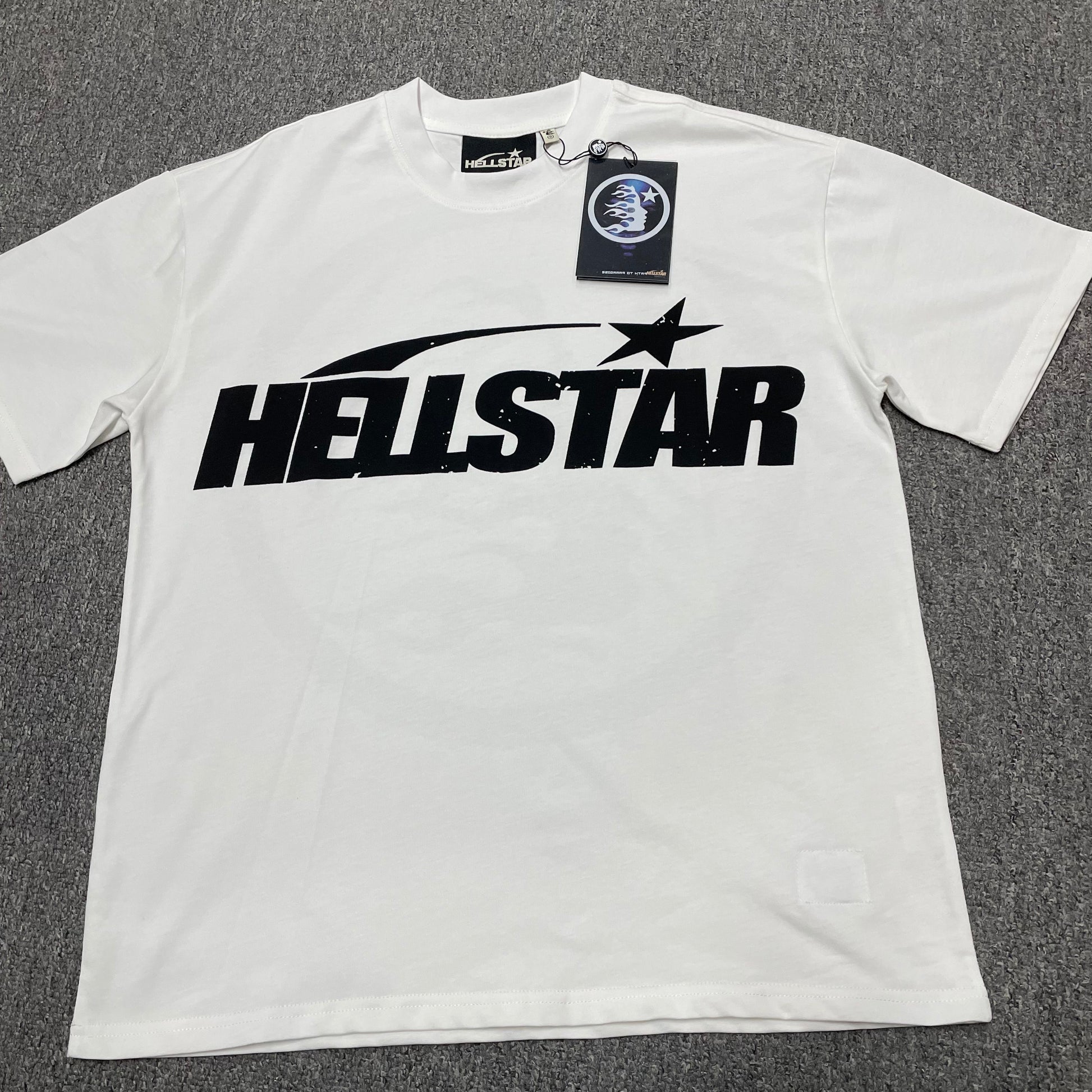 Hellstar Sports Logo T-Shirt in white front view with oversized black wordmark and shooting-star graphic