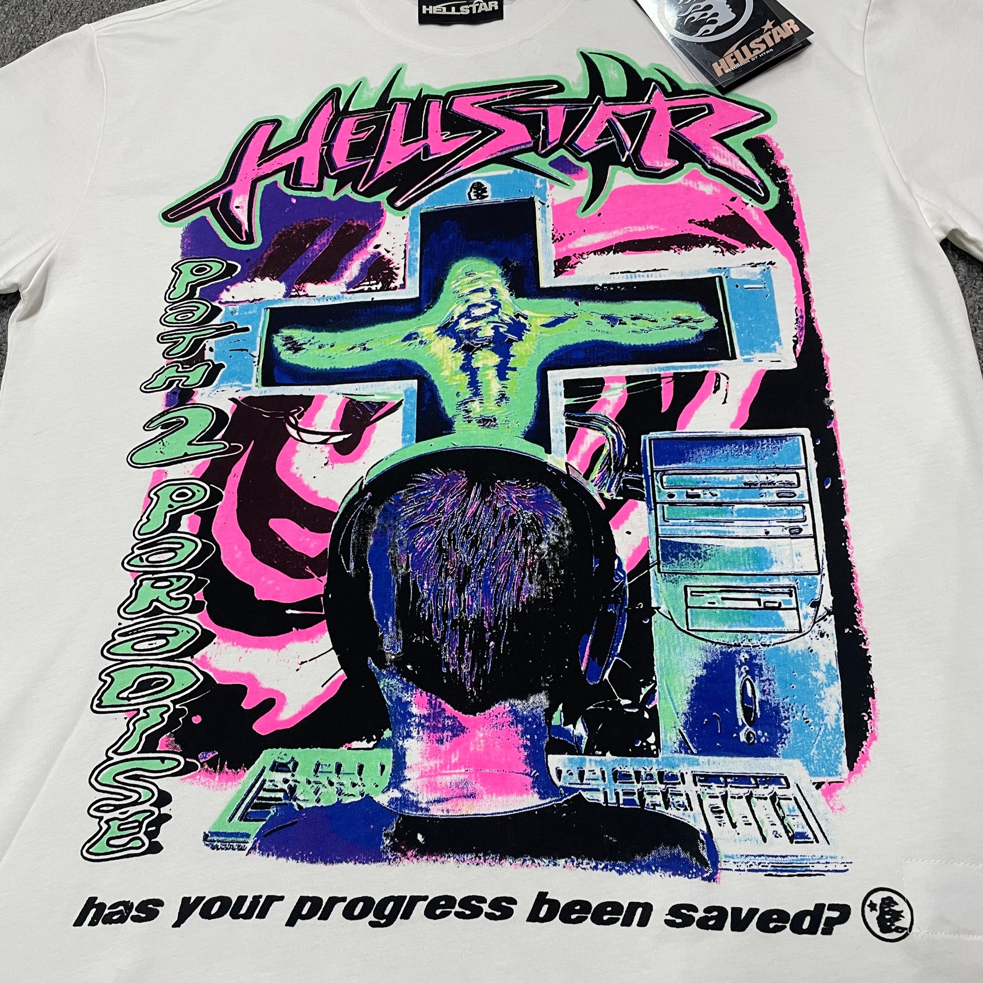 Full multicolor cyber graphic on the front of the white Hellstar Online T-Shirt
Cyber cross graphic detail on the Hellstar Online Has Your Progress Been Saved T-Shirt
Path 2 Paradise vertical lettering detail on the Hellstar Online T-Shirt
Has Your Progress Been Saved slogan detail on the white Hellstar Online T-Shirt