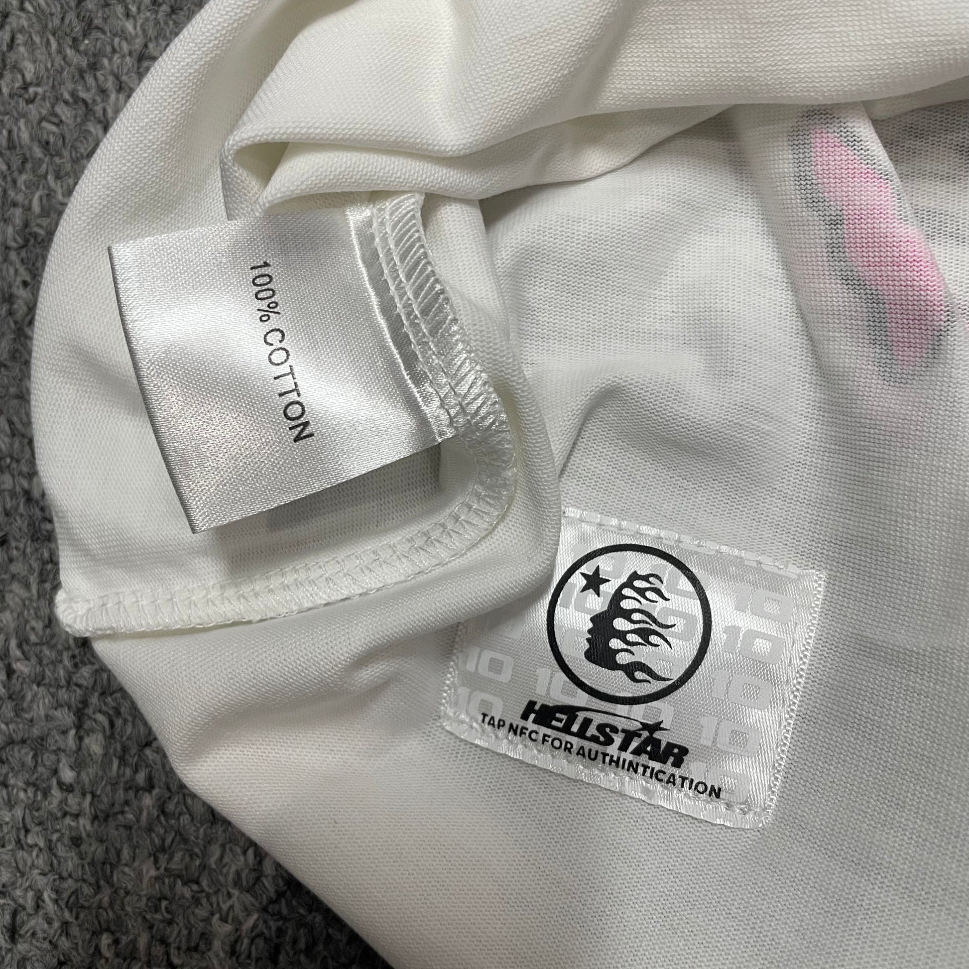 NFC tag detail on the Hellstar Helmet Tee for wholesale product inspection
Hellstar Helmet Tee wash label showing size fabric and garment care information