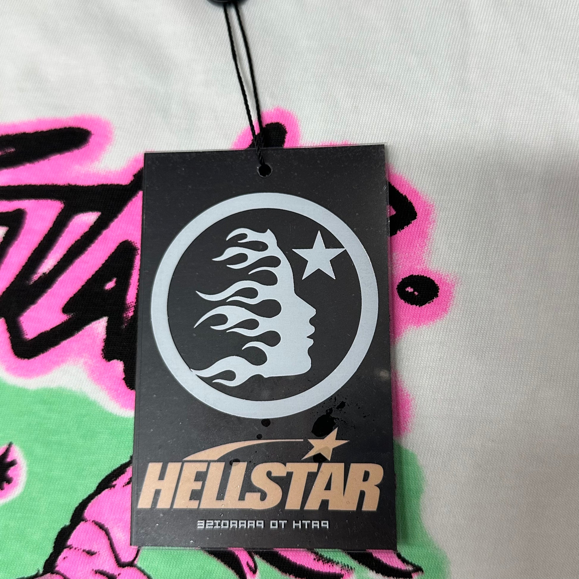 Hellstar branded hangtag attached to the White and Pink No Guts No Glory T-Shirt