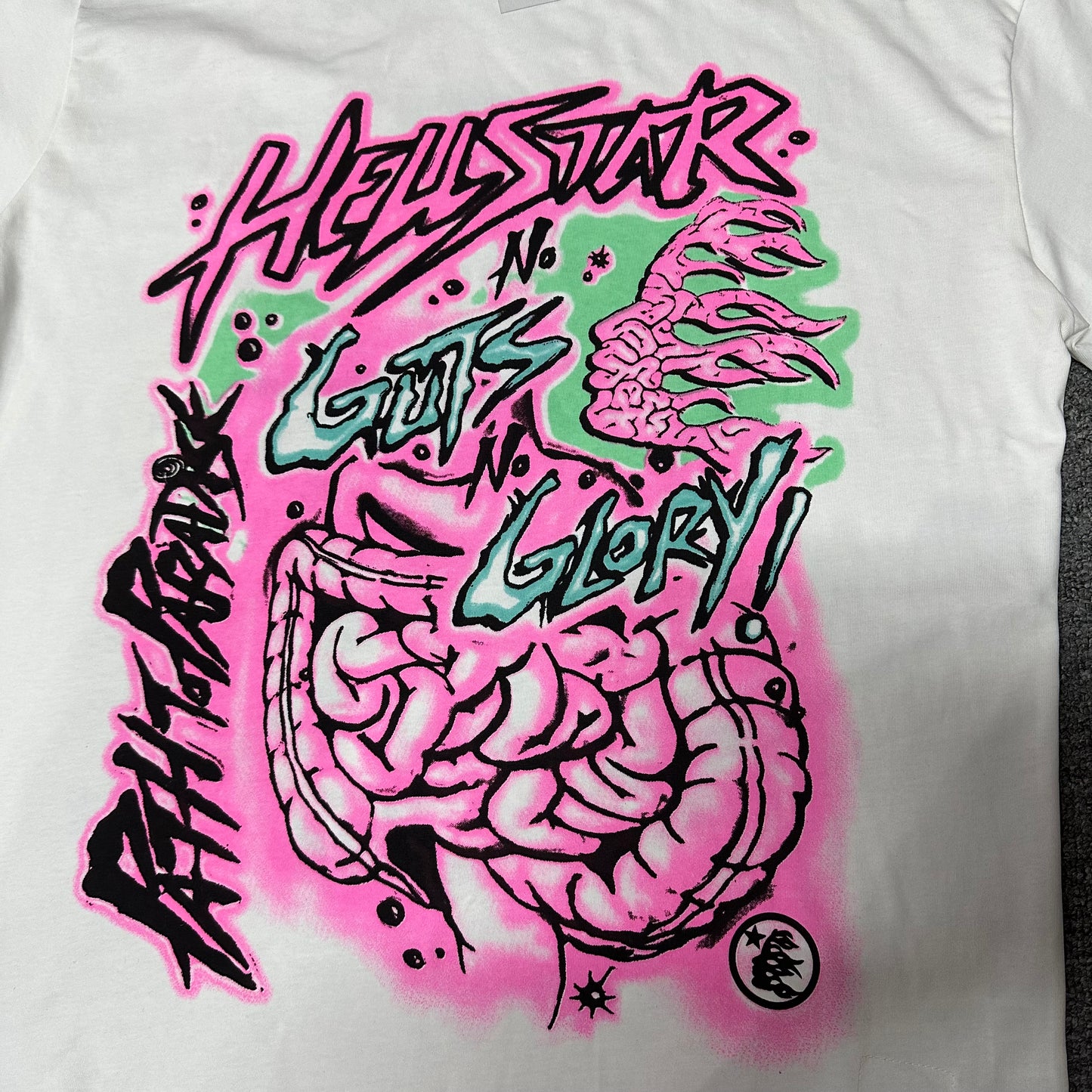 Full pink anatomy graphic on the front of the Hellstar No Guts No Glory T-Shirt
Close-up of the pink black and mint graphic print on the Hellstar No Guts No Glory T-Shirt
Detailed view of the layered anatomy print texture on the Hellstar graphic T-shirt
Pink Hellstar logo graphic with black outline on the White No Guts No Glory T-Shirt
Close-up of the pink and black Hellstar lettering on the White graphic T-shirt