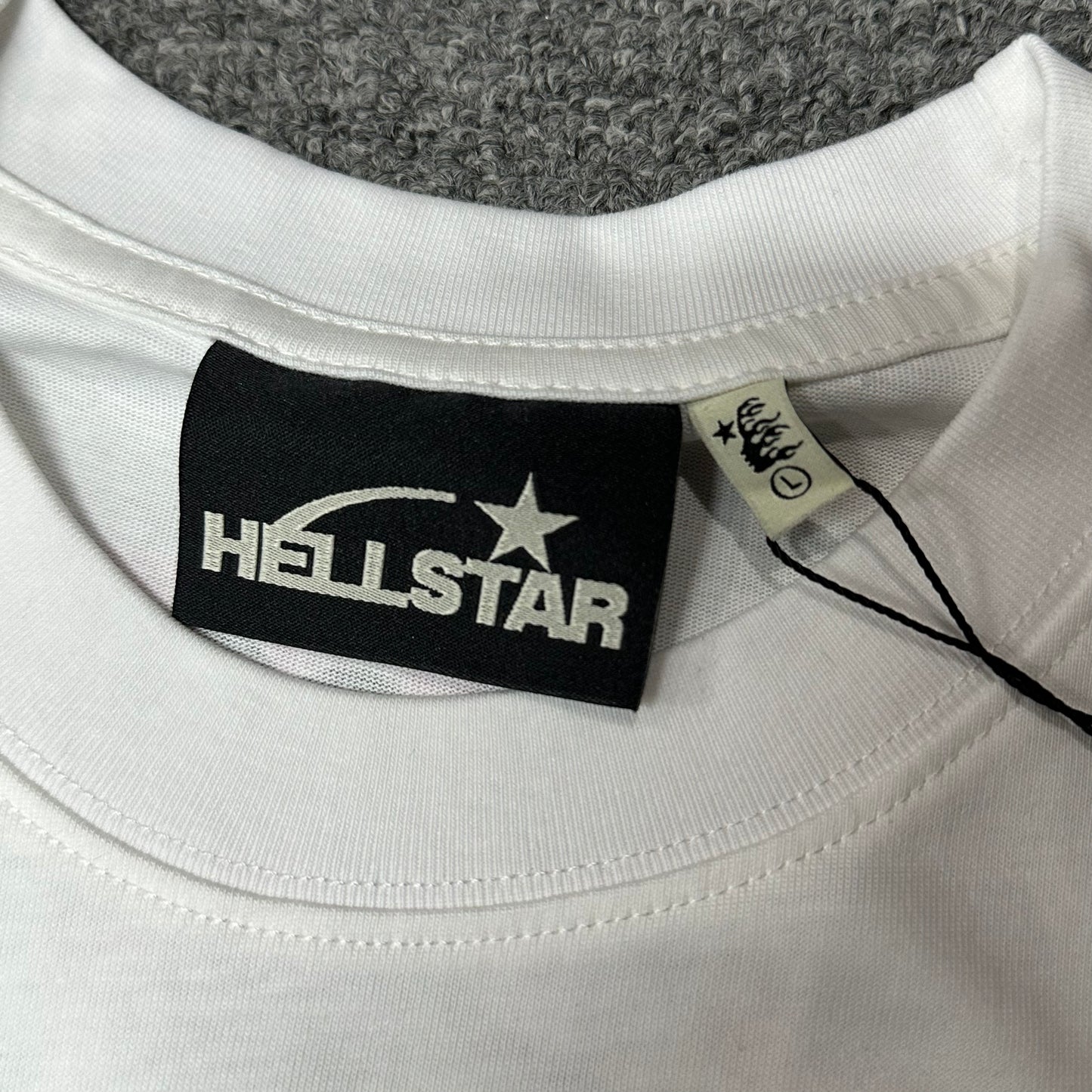 Hellstar branded neck label and crew-neck stitching on the No Guts No Glory T-Shirt
Size label detail inside the Hellstar No Guts No Glory graphic T-shirt