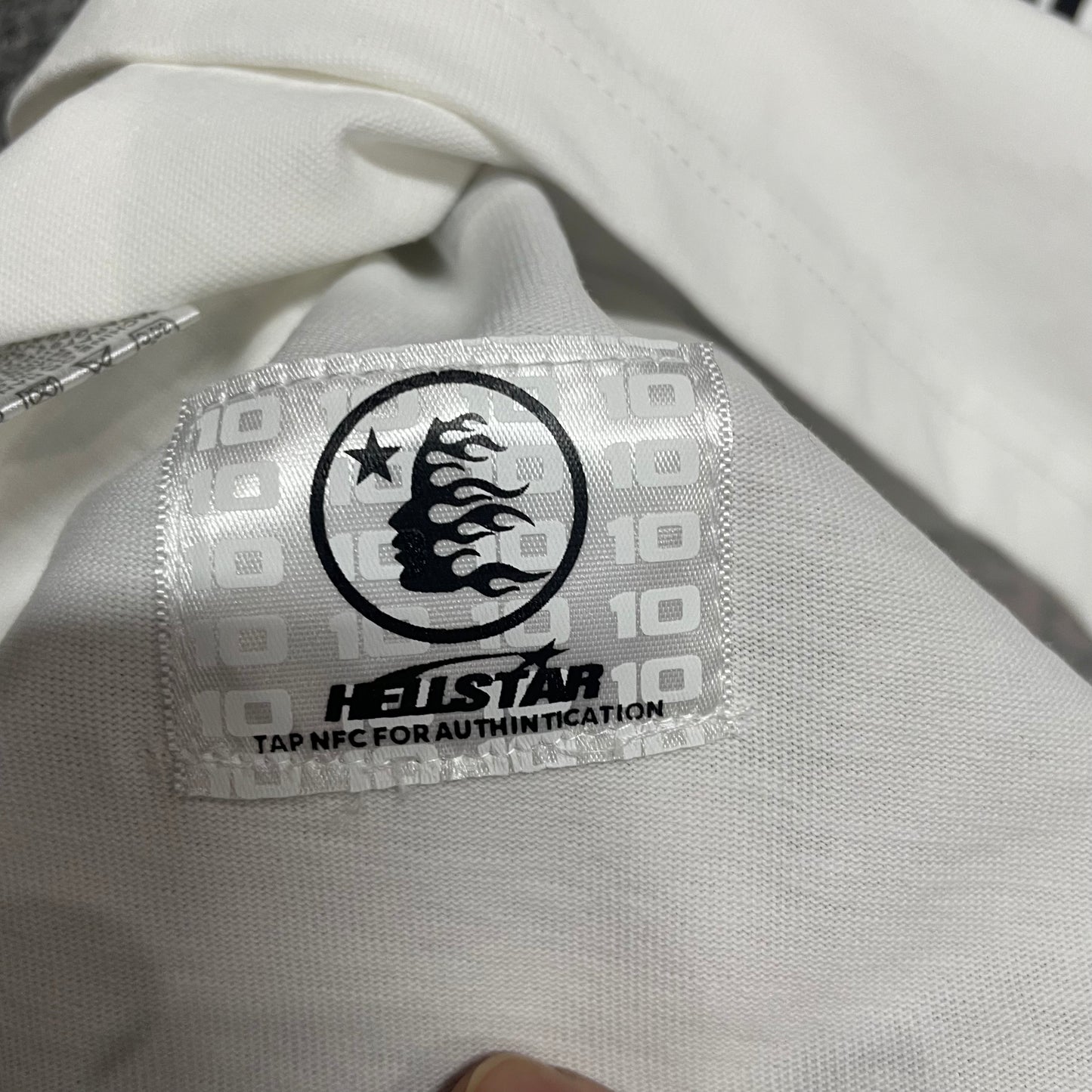 NFC tag detail on the Hellstar Pixel T-Shirt for wholesale product inspection