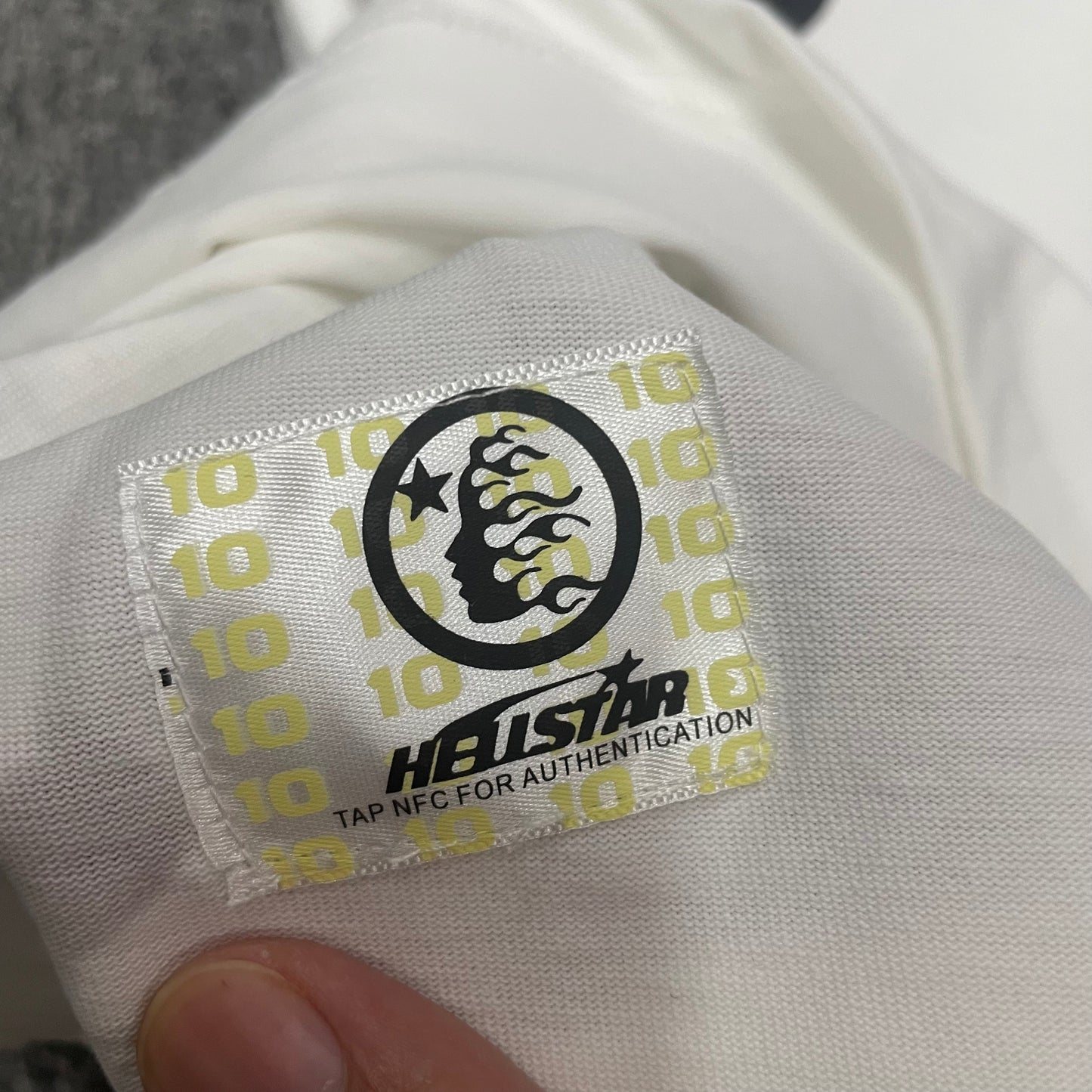 NFC tag detail on the Hellstar Path to Paradise T-Shirt for product inspection