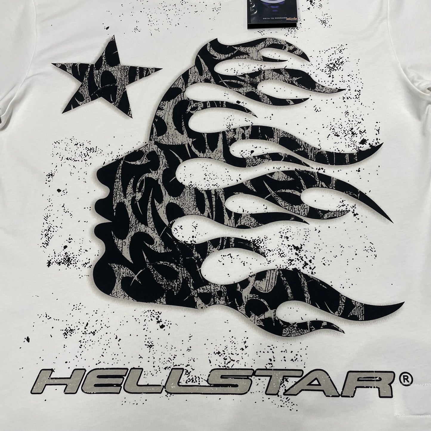 Full black flame-profile graphic printed across the front of the Hellstar Flame Tribal Motion T-Shirt
Close-up of the oversized black tribal flame artwork on the Hellstar graphic T-shirt
Detailed view of the distressed black print texture on the Hellstar Flame Tribal Motion T-Shirt
Black side-profile silhouette with flowing flame details on the Hellstar Flame Tribal Motion T-Shirt

