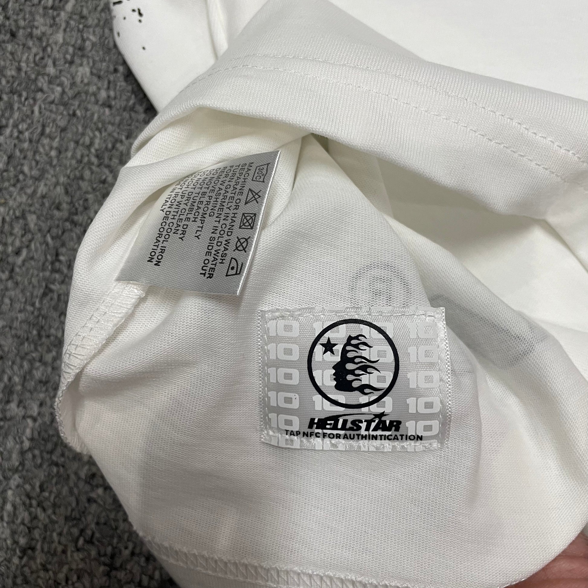NFC tag detail on the Hellstar Flame Tribal Motion T-Shirt for product inspection