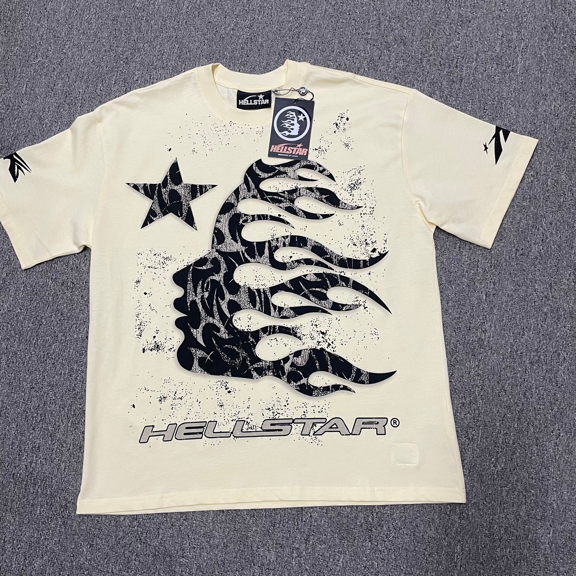 Hellstar Flame Tribal Motion T-Shirt in Cream front view with oversized black tribal flame graphic