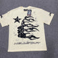 Hellstar Flame Tribal Motion T-Shirt in Cream front view with oversized black tribal flame graphic