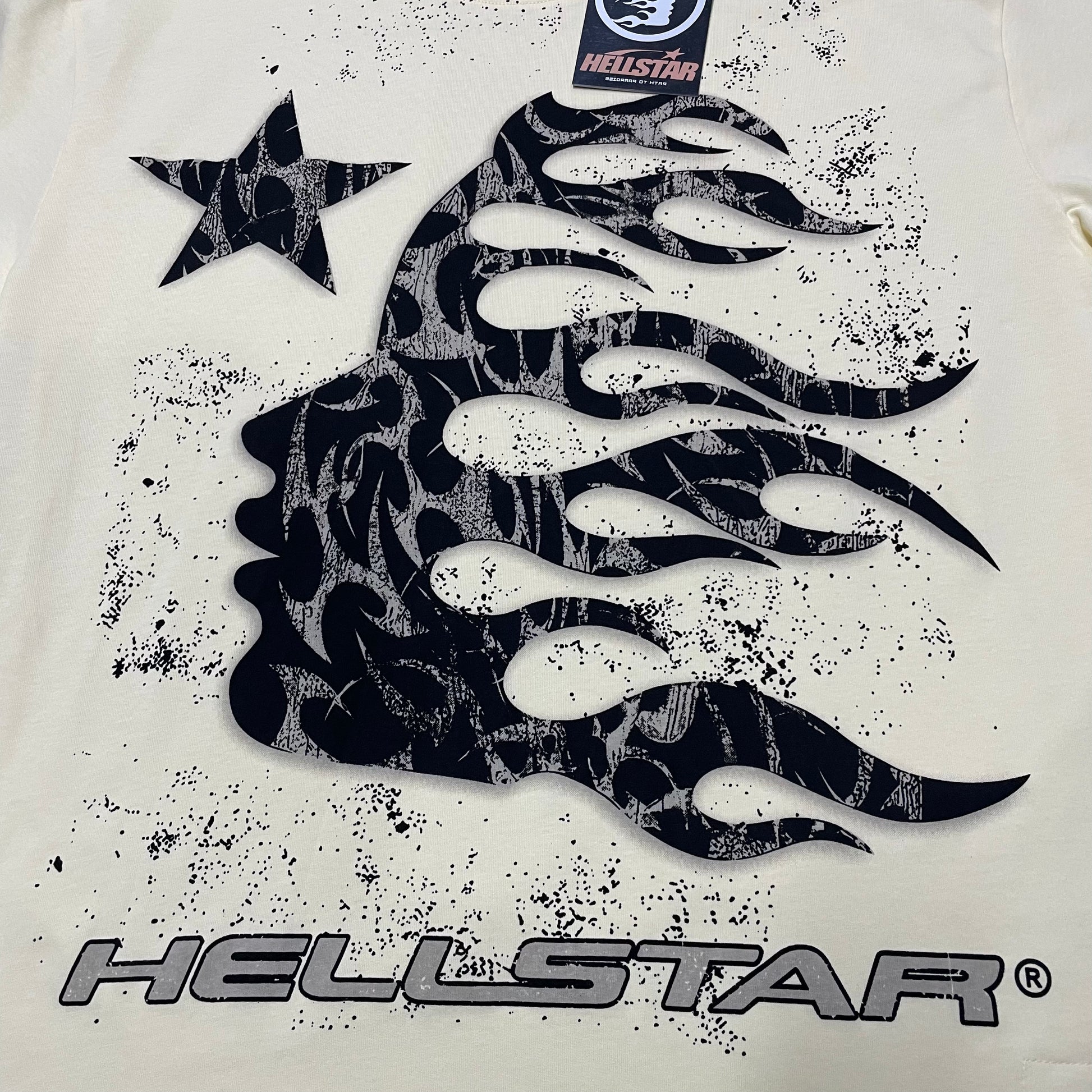 Full black flame-profile graphic printed across the front of the Hellstar Flame Tribal Motion T-Shirt
Close-up of the oversized black tribal flame artwork on the Hellstar graphic T-shirt
Detailed view of the distressed black print texture on the Hellstar Flame Tribal Motion T-Shirt
Black side-profile silhouette with flowing flame details on the Hellstar Flame Tribal Motion T-Shirt