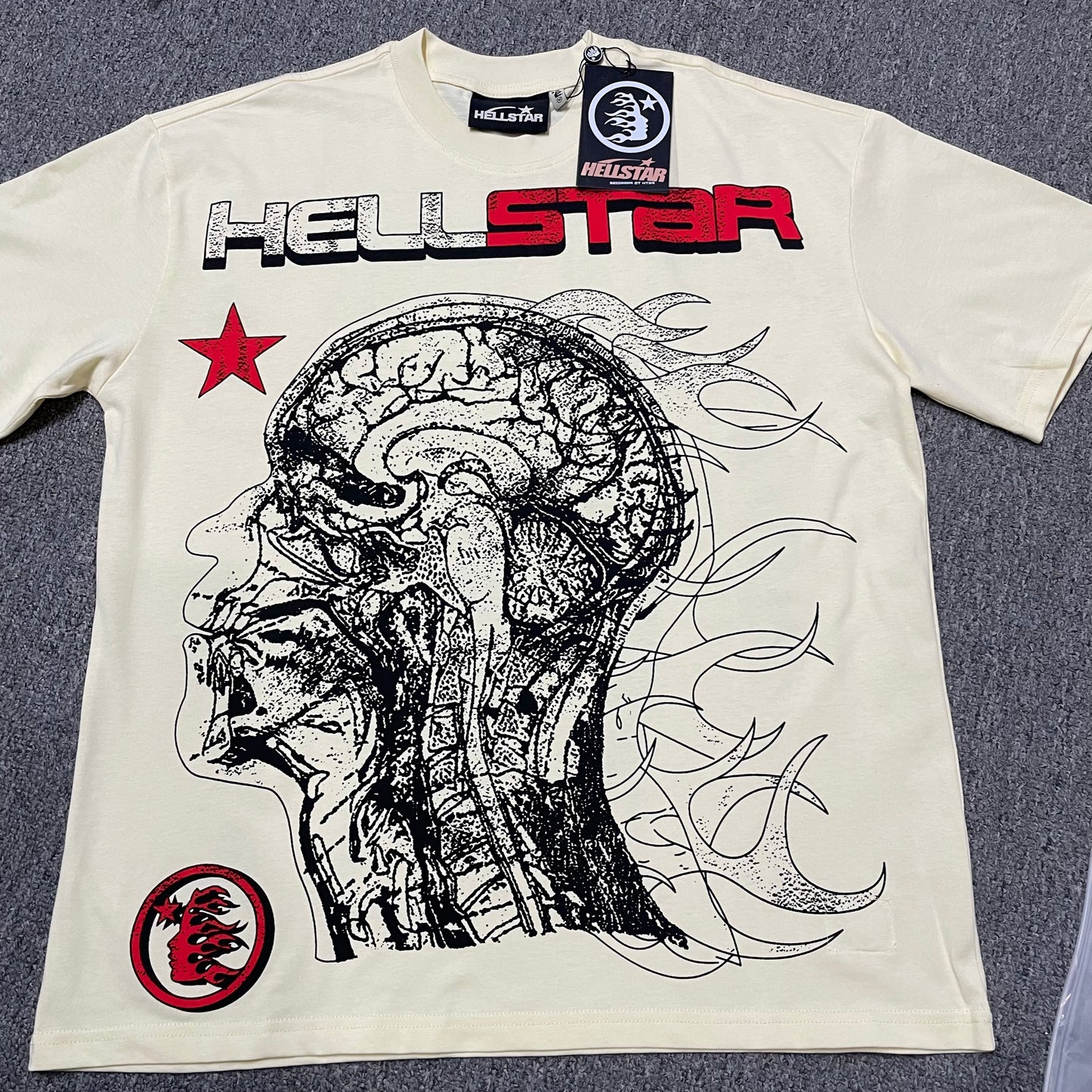 Hellstar Human Development T-Shirt in cream front view with oversized anatomical head graphic